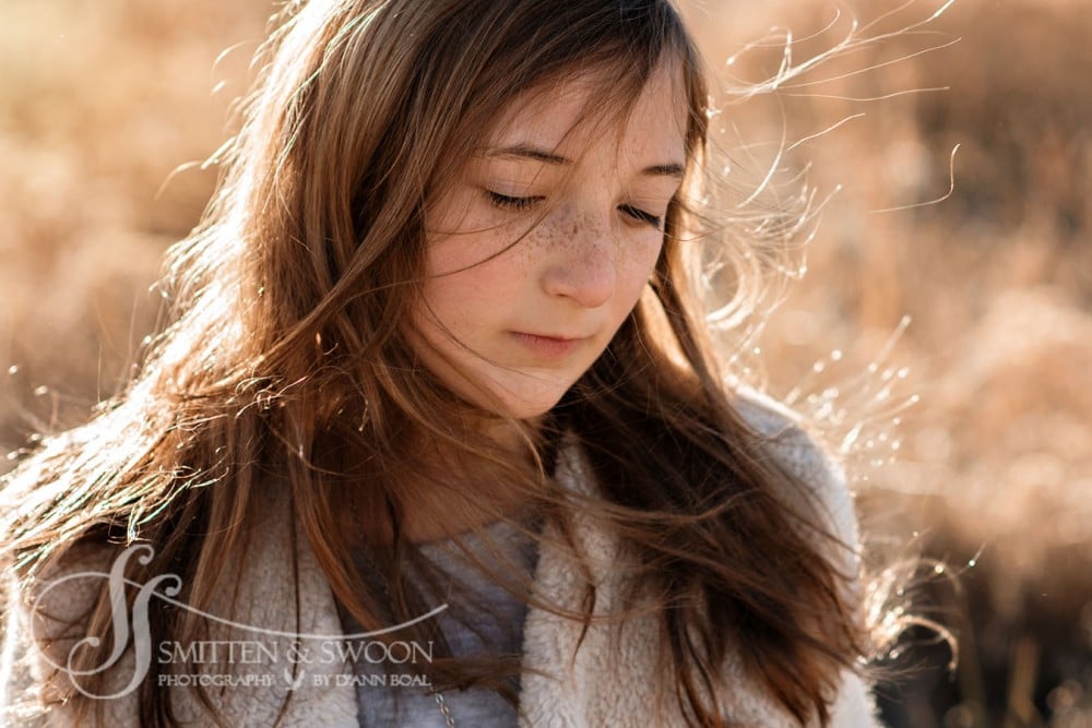 11 year old girl with wind blowing into her freckled face {boulder child photographer}
