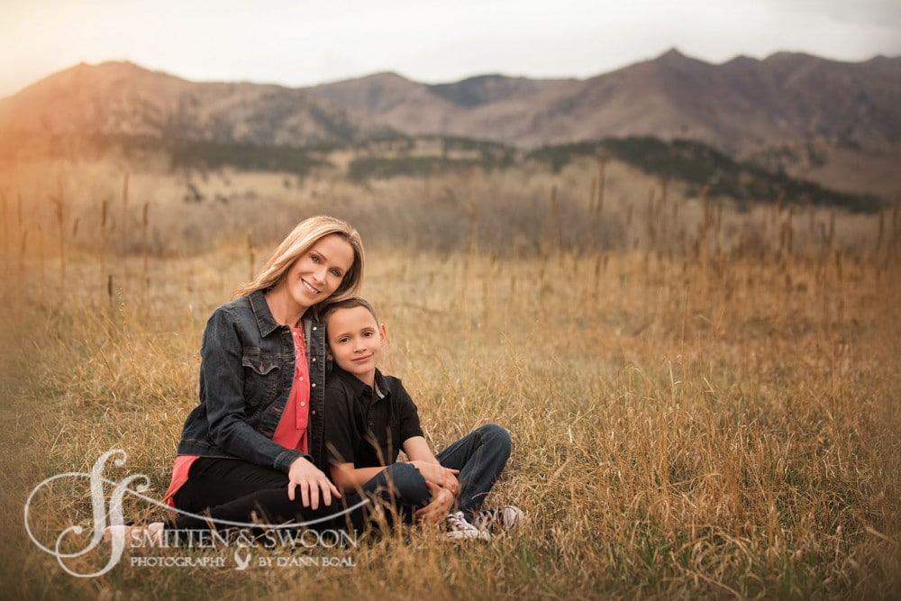 mother and son in a field at sunset