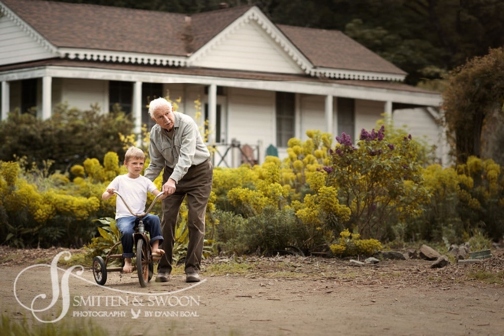 grandpa helping boy ride tricycle on a farm {boulder child photographer}